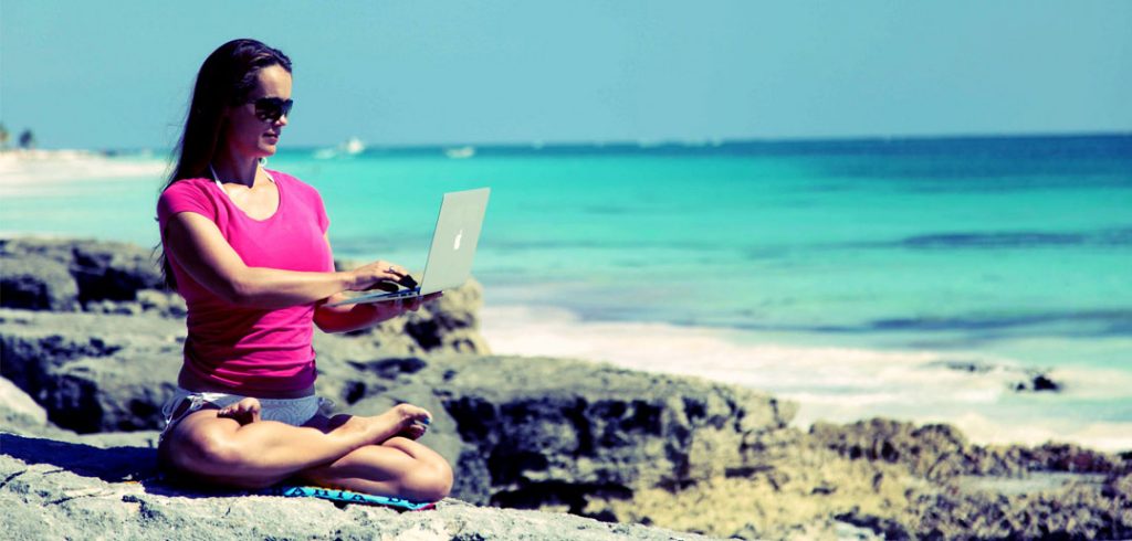 7 Websites To Visit If You Want To Be a Better Manager Be a better manager looking at websites on a beach
